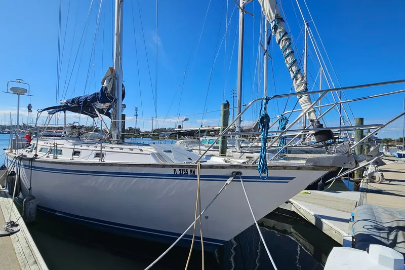 Slide: The Image of Sailboat Endeavor 42, 1989 model, docked at marina under clear blue sky. - 4