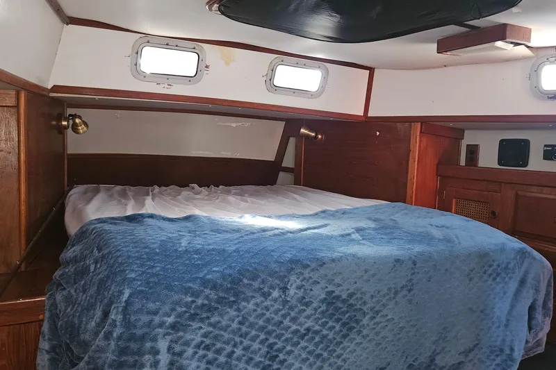 Slide: The Image of Cozy cabin interior of 1989 ENDEAVOR 42 sailboat with bed and portholes. - 41