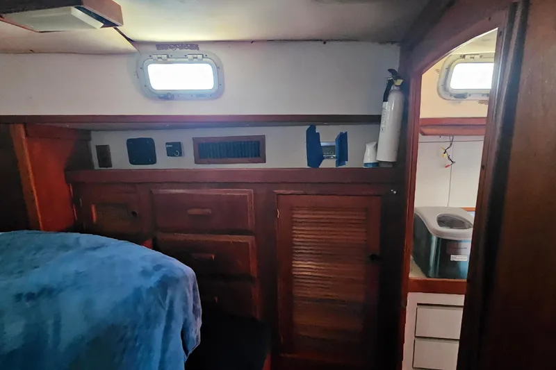 Slide: The Image of Cozy cabin interior of 1989 ENDEAVOR 42 sailboat with wooden cabinetry and porthole. - 43