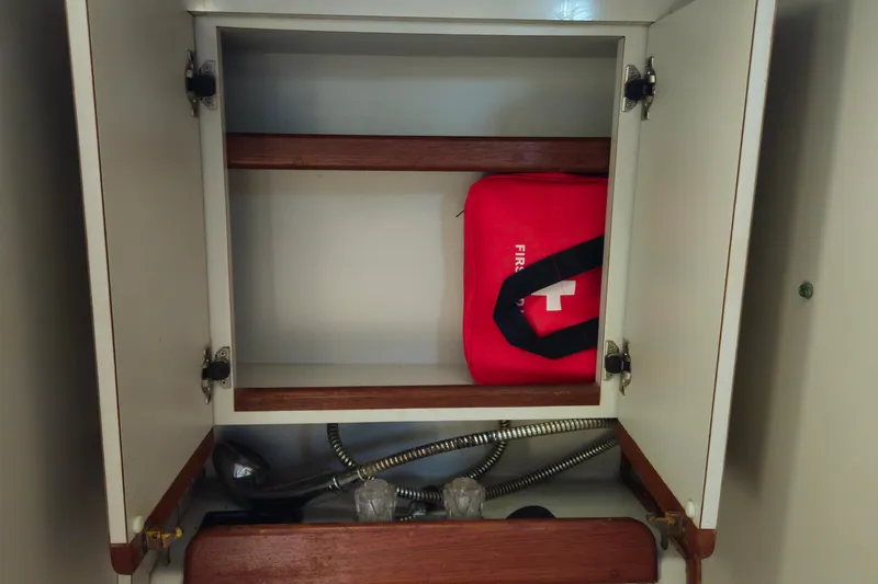 Slide: The Image of Open cabinet with red first aid kit inside, Endeavor 42, 1989 model. - 47