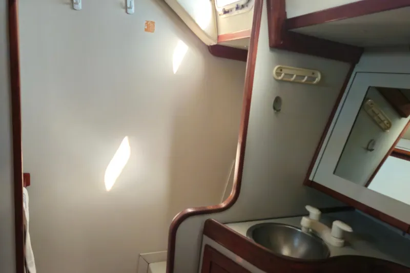 Slide: The Image of Interior of 1989 ENDEAVOR 42 yacht bathroom with sink and mirror. - 49