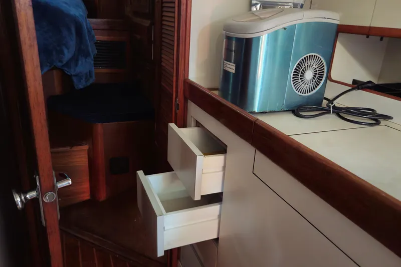 Slide: The Image of Interior of 1989 ENDEAVOR 42 yacht with open drawers and ice maker. - 53