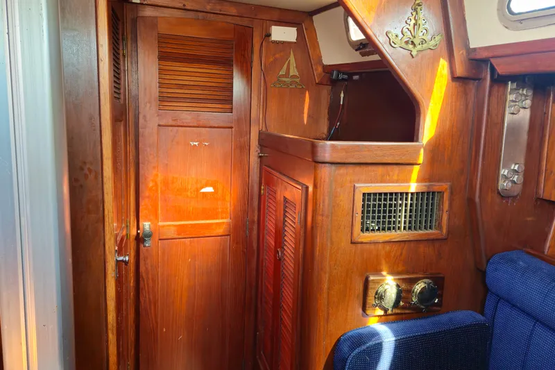Slide: The Image of Interior of 1989 ENDEAVOR 42 sailboat with wooden cabinetry and blue seating. - 55