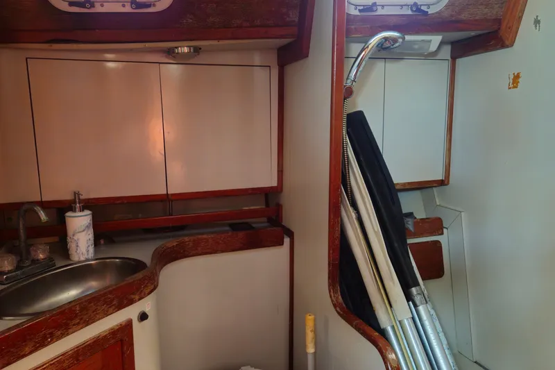 Slide: The Image of Interior of 1989 ENDEAVOR 42 sailboat with sink and storage cabinets. - 56