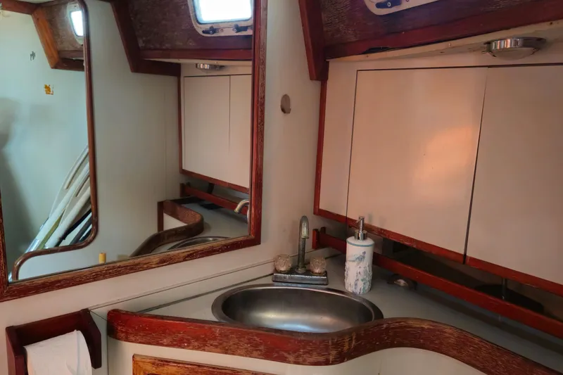 Slide: The Image of Bathroom interior of 1989 ENDEAVOR 42 yacht with sink, mirror, and wooden accents. - 58