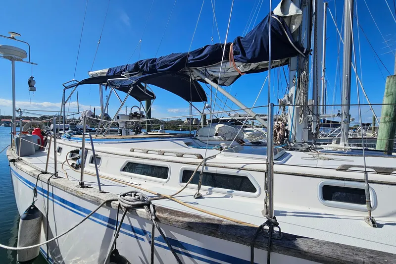 Slide: The Image of Sailboat Endeavor 42, 1989 model, docked at marina under clear blue sky. - 6