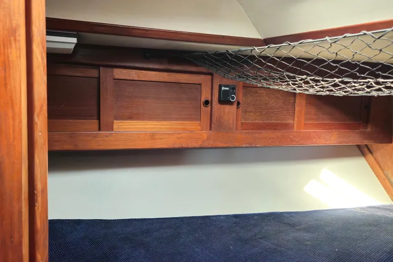 Slide: The Image of Interior cabin of 1989 ENDEAVOR 42 sailboat with wooden storage and netting. - 61