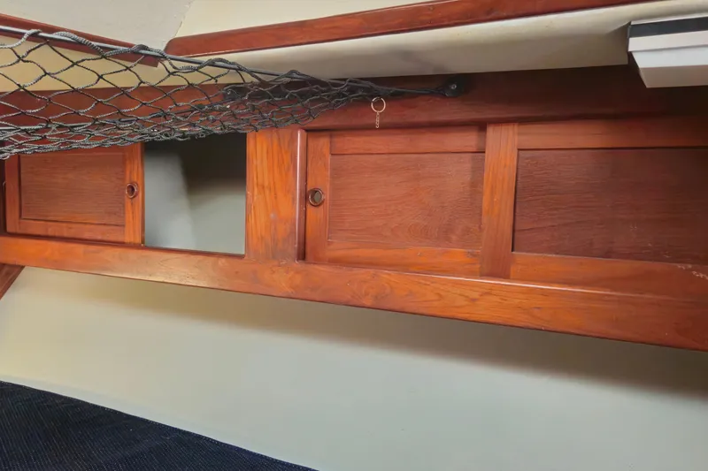 Slide: The Image of Wooden storage cabinet with sliding doors inside 1989 ENDEAVOR 42 boat cabin. - 62
