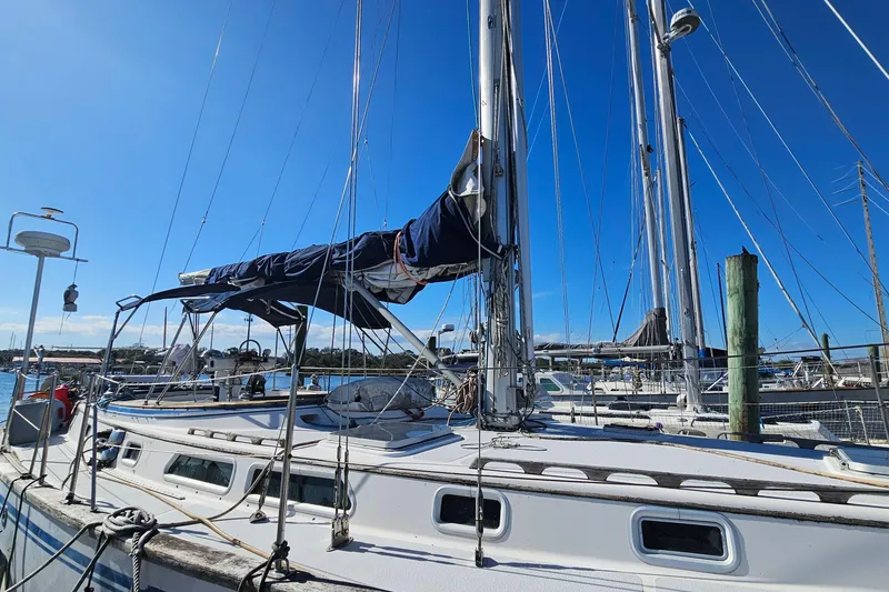 Slide: The Image of Sailboat ENDEAVOR 42, 1989 model, docked at marina under clear blue sky. - 69