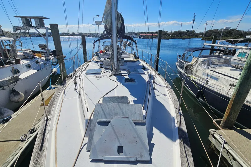 Slide: The Image of Sailboat Endeavor 42, 1989 model, docked at marina under clear blue sky. - 8
