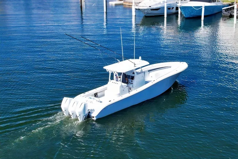 The Image of 2023 Yellowfin 36 Offshore boat cruising in a marina with clear blue water. - 1
