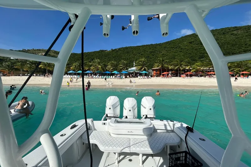 Slide: The Image of 2023 Yellowfin 36 Offshore boat near tropical beach with turquoise water and palm trees. - 12