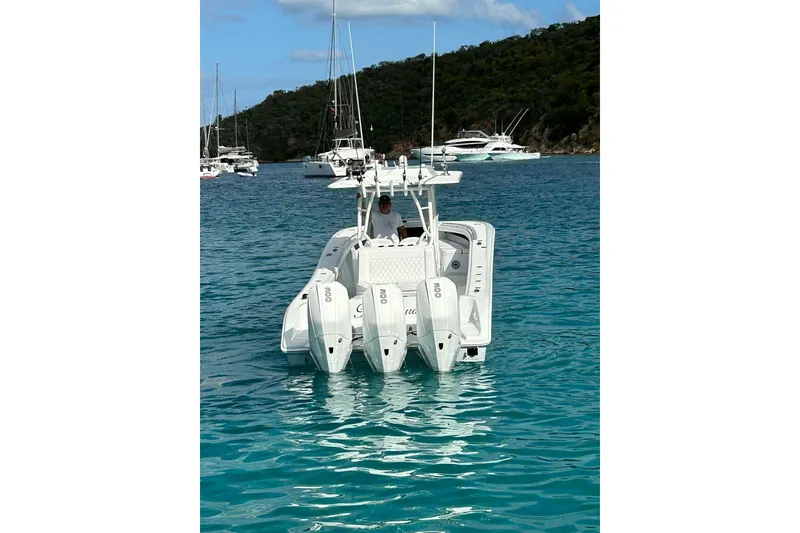 Slide: The Image of 2023 Yellowfin 36 Offshore boat with triple engines in clear blue water. - 14