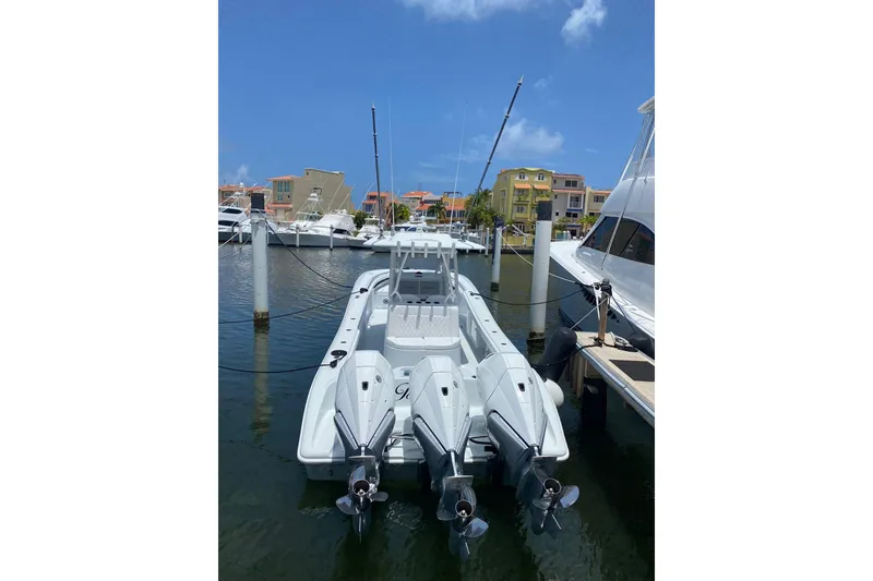 Slide: The Image of 2023 Yellowfin 36 Offshore boat docked in marina under clear blue sky. - 15