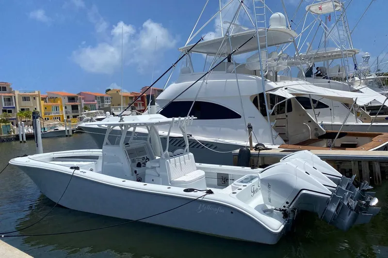 Slide: The Image of 2023 Yellowfin 36 Offshore boat docked at marina, clear sky background. - 19