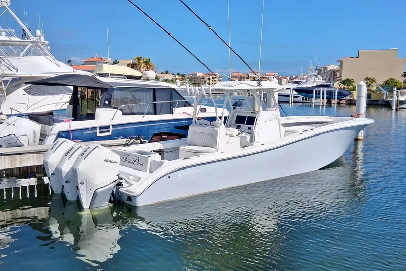 Slide: The Image of 2023 Yellowfin 36 Offshore boat docked in marina, featuring triple Mercury engines. - 6