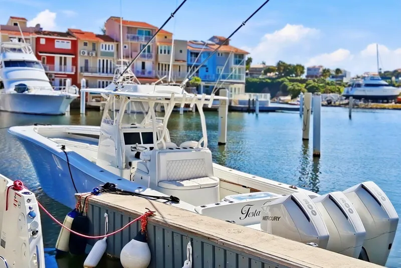 Slide: The Image of 2023 Yellowfin 36 Offshore boat docked in a vibrant marina setting. - 7