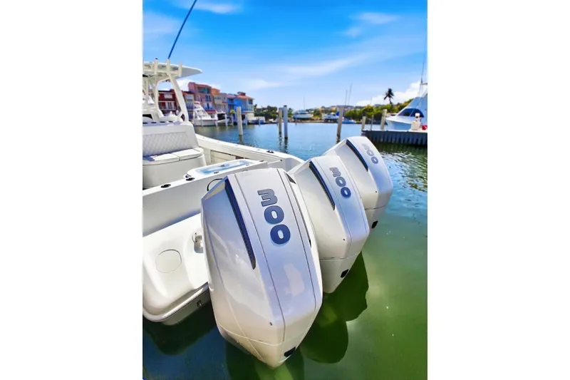 Slide: The Image of 2023 Yellowfin 36 Offshore boat with triple outboard engines docked in marina. - 8