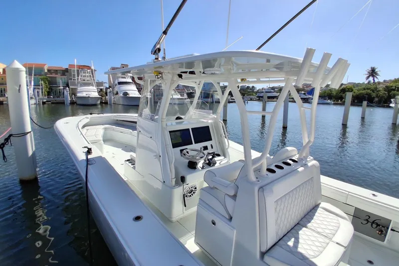 Slide: The Image of 2023 Yellowfin 36 Offshore boat docked in a marina under clear blue skies. - 9