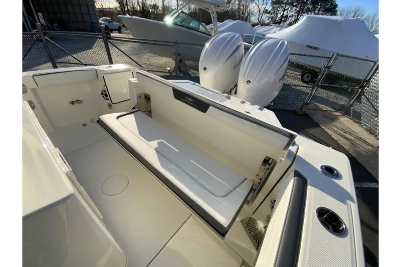 Slide: The Image of 2026 Cobia 245 Center Console boat interior with dual engines and seating area. - 14
