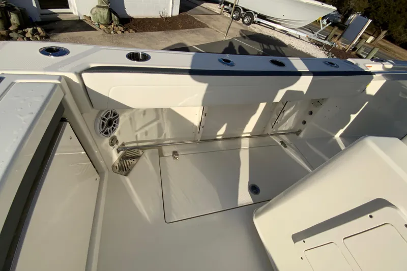 Slide: The Image of 2026 Cobia 245 Center Console boat interior with storage compartments and cup holders. - 16