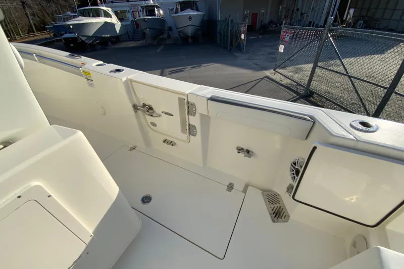 Slide: The Image of 2026 Cobia 245 Center Console boat interior with storage compartments and clean deck design. - 17