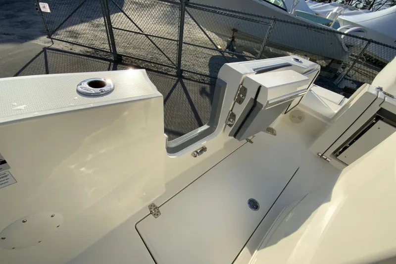 Slide: The Image of 2026 Cobia 245 Center Console boat interior with storage compartments and rod holders. - 18