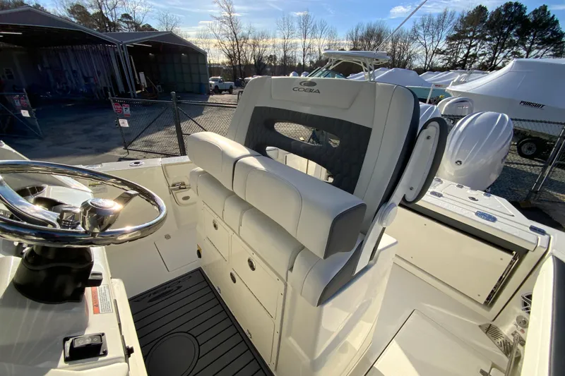 Slide: The Image of 2026 Cobia 245 Center Console boat interior with steering wheel and seating. - 21