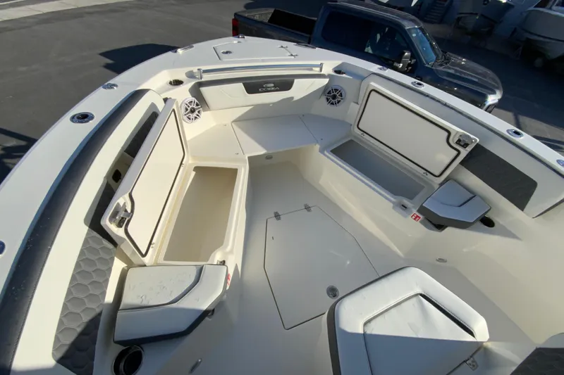 Slide: The Image of 2026 Cobia 245 Center Console boat interior with open storage compartments and seating. - 25