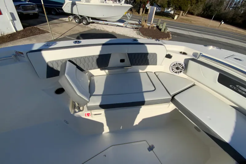 Slide: The Image of 2026 Cobia 245 Center Console boat interior with cushioned seating and speaker system. - 27