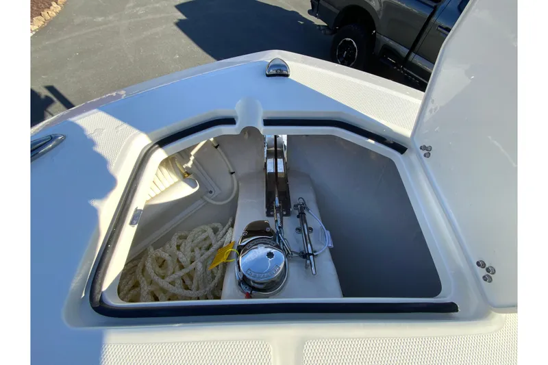 Slide: The Image of 2026 Cobia 245 Center Console anchor storage with rope and winch. - 29