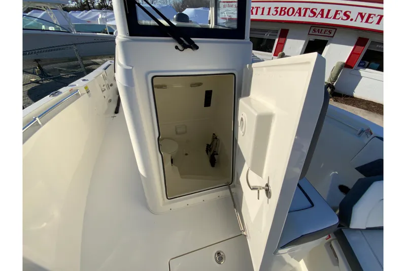 Slide: The Image of 2026 Cobia 245 Center Console boat with open storage compartment. - 32