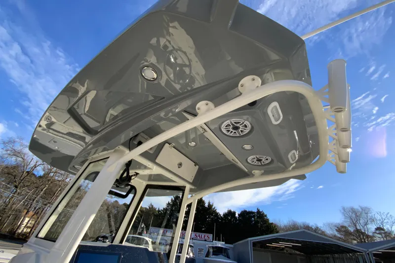 Slide: The Image of 2026 Cobia 245 Center Console boat with sleek T-top and integrated speakers. - 34