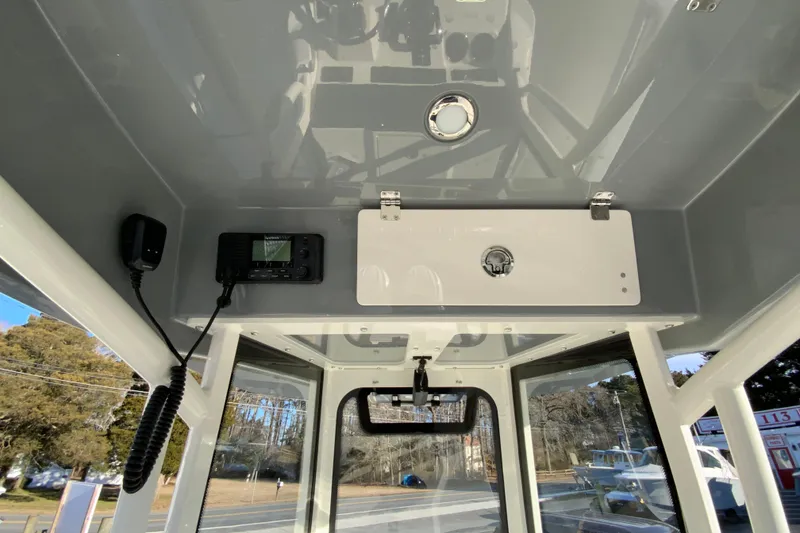 Slide: The Image of Interior view of 2026 Cobia 245 Center Console boat with navigation equipment. - 35