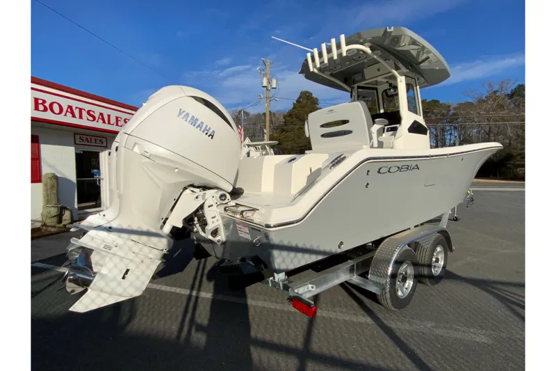 Slide: The Image of 2026 Cobia 245 Center Console boat with Yamaha engine at dealership. - 9