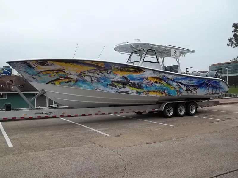 Slide: The Image of 2018 Yellowfin 39 Offshore boat with colorful fish design. - 2