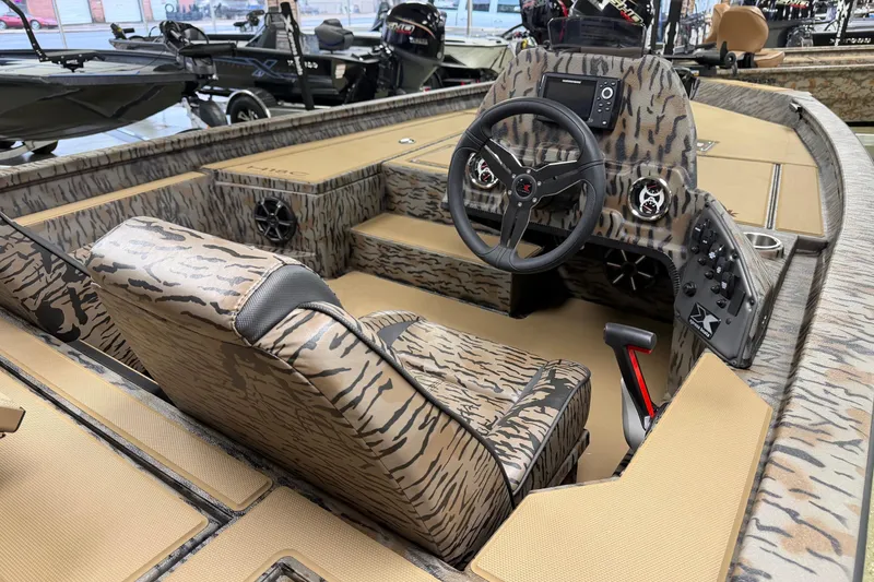 Slide: The Image of 2026 Xpress H18C Crappie boat interior with camouflage design and modern controls. - 3