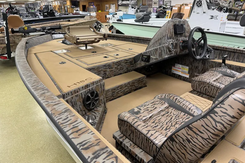 Slide: The Image of 2026 Xpress H18C Crappie boat with camo interior and advanced controls. - 4