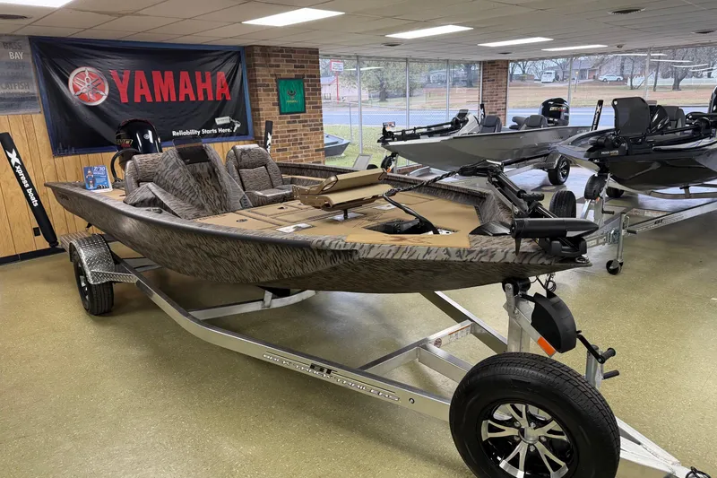 Slide: The Image of 2026 Xpress H18C Crappie boat on display with Yamaha banner in showroom. - 6