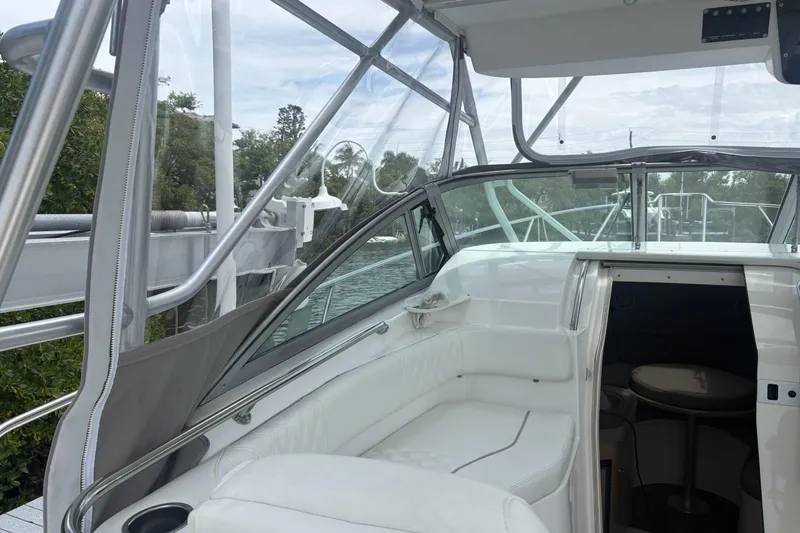 Slide: The Image of 2001 Boston Whaler 285 Conquest interior with white seating and cabin entrance. - 13