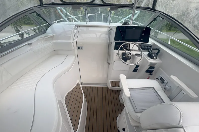 Slide: The Image of Interior of 2001 Boston Whaler 285 Conquest boat, featuring helm and seating area. - 5