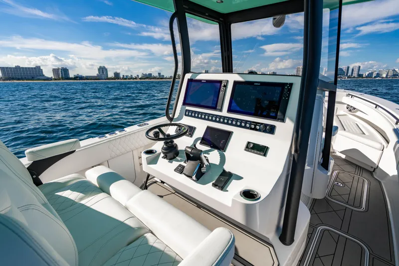 Slide: The Image of 2026 Reef Runner 340 boat cockpit with advanced navigation systems on a sunny day. - 14