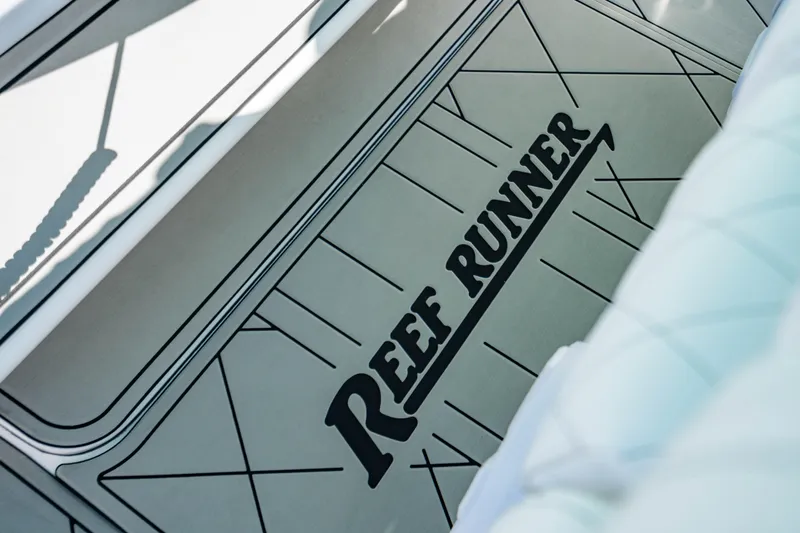 Slide: The Image of 2026 Reef Runner 340 boat deck with logo and geometric design. - 20