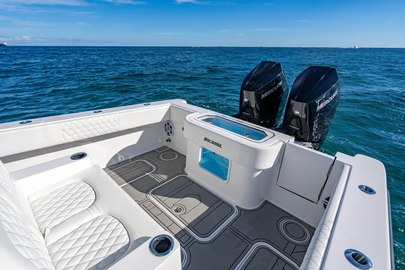 Slide: The Image of 2026 Reef Runner 340 boat with dual Mercury engines on open sea. - 9