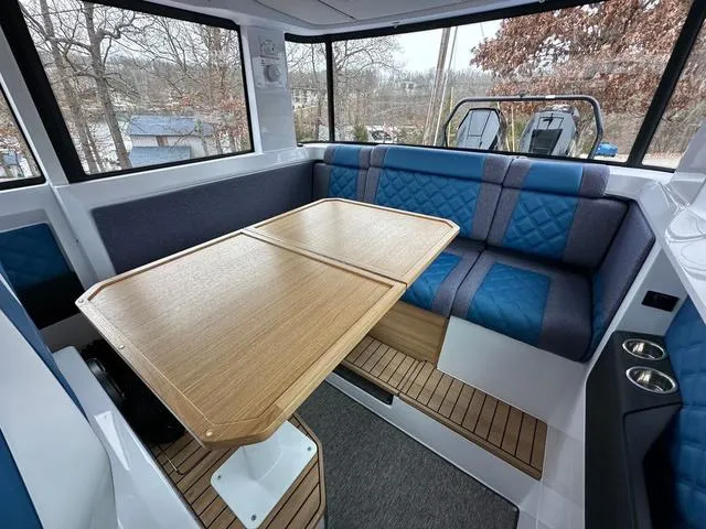 Slide: The Image of 2025 Axopar 37 XC Cross Cabin boat docked at a marina, showcasing sleek design. - 10