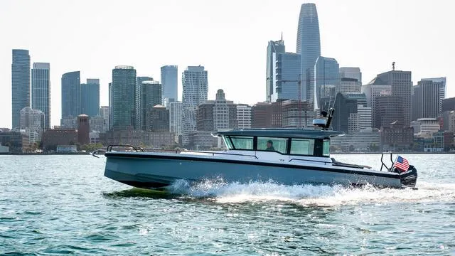 Slide: The Image of 2025 Axopar 37 XC Cross Cabin dashboard with navigation screens and controls. - 14