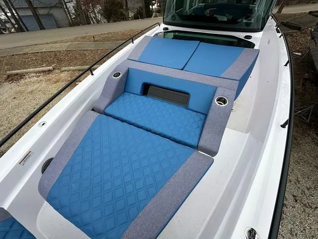 Slide: The Image of Interior of 2025 Axopar 37 XC Cross Cabin with blue quilted panel and cup holders. - 5
