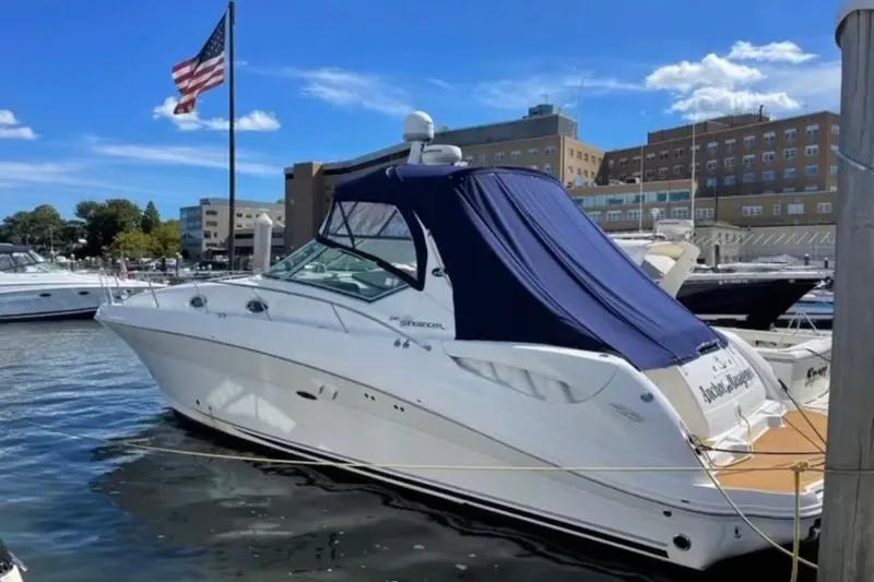 The Image of 2006 Sea Ray 340 Sundancer yacht docked at marina under clear blue sky. - 0