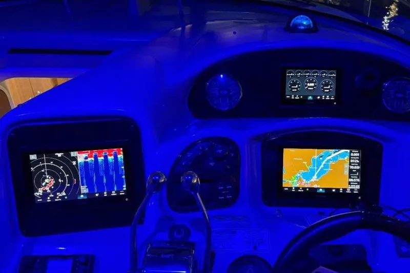 Slide: The Image of Control panel of 2006 Sea Ray 340 Sundancer boat illuminated in blue light. - 6