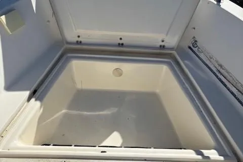 Slide: The Image of 2001 Sea Pro 190 Dual Console storage compartment, open lid, spacious interior. - 10